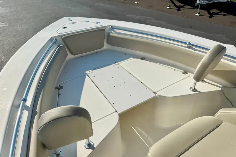 Slide: The Image of 2022 Key West 219 FS boat interior with cushioned seating and storage compartments. - 17