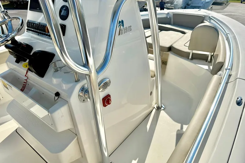 Slide: The Image of 2022 Key West 219 FS boat interior with steering console and seating area. - 23