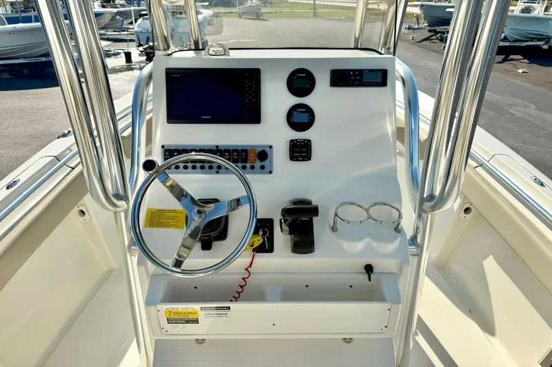 Slide: The Image of 2022 Key West 219 FS boat console with steering wheel, gauges, and navigation equipment. - 25