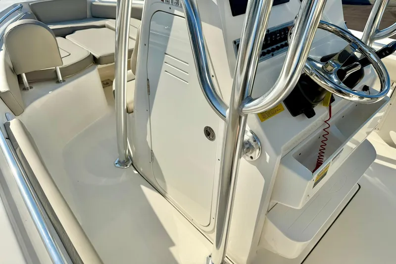 Slide: The Image of 2022 Key West 219 FS boat interior with steering console and seating area. - 26