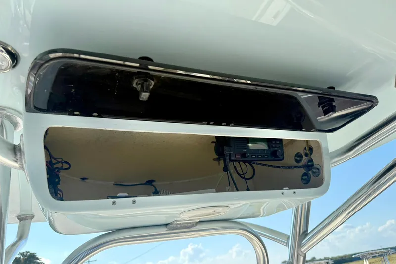 Slide: The Image of 2022 Key West 219 FS boat console with electronic equipment and storage compartment. - 29