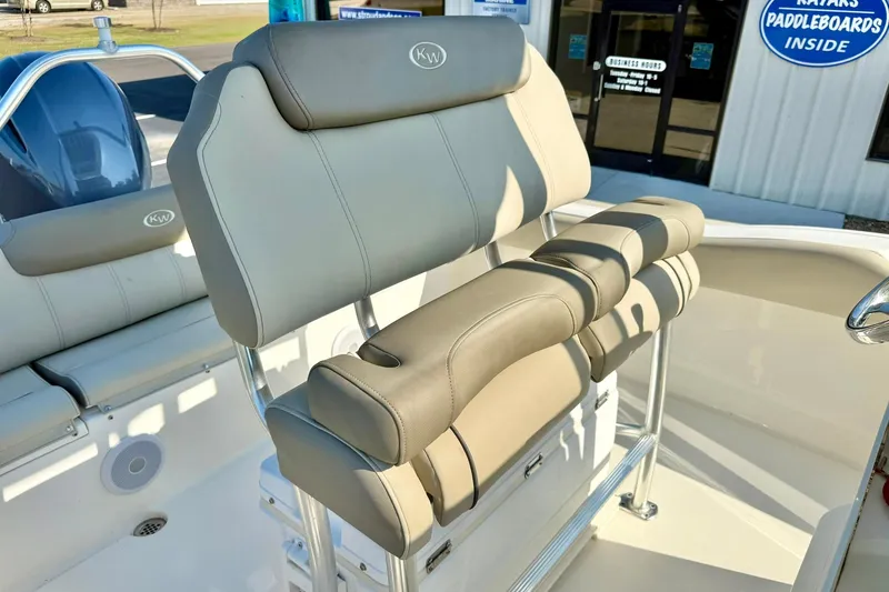 Slide: The Image of 2022 Key West 219 FS boat seating with beige upholstery and stainless steel frame. - 31