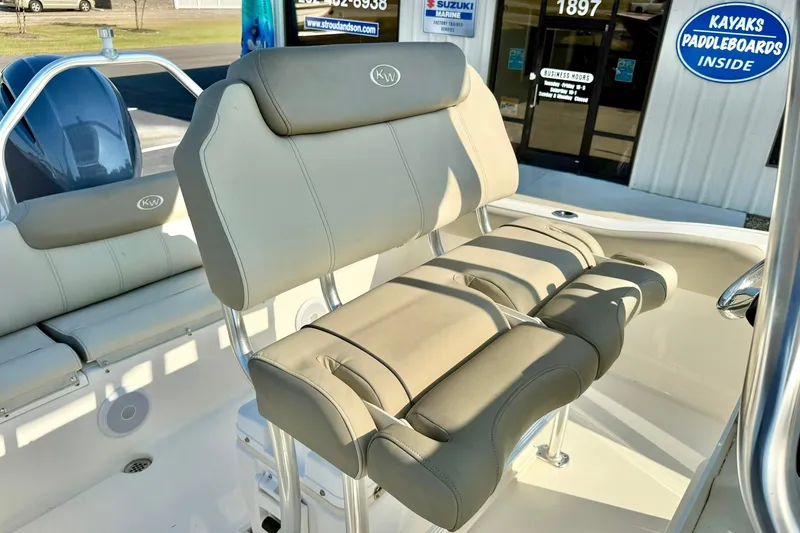 Slide: The Image of 2022 Key West 219 FS boat interior with beige seating and stainless steel accents. - 32