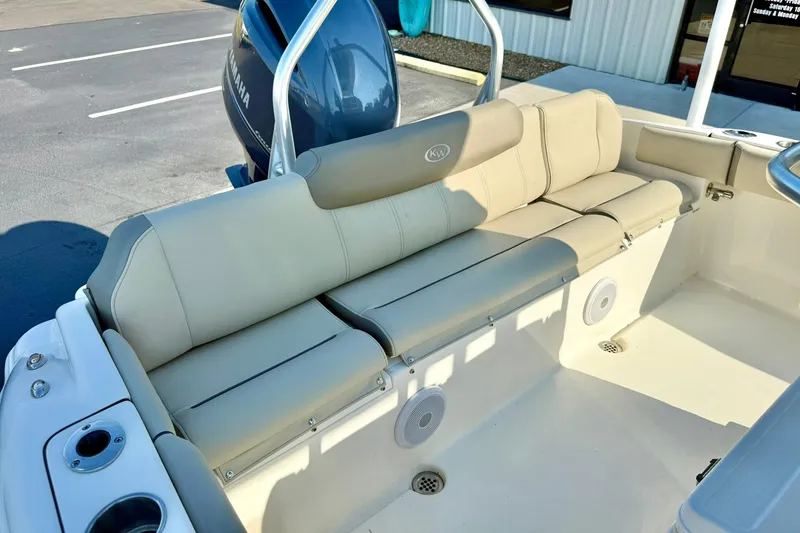 Slide: The Image of 2022 Key West 219 FS boat interior with beige seating and Yamaha engine. - 37