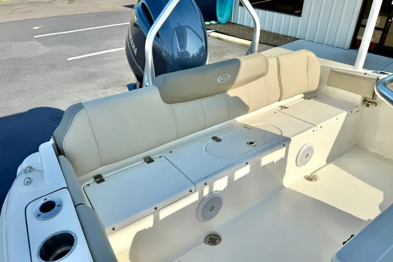 Slide: The Image of 2022 Key West 219 FS boat interior with beige seating and Yamaha engine. - 38
