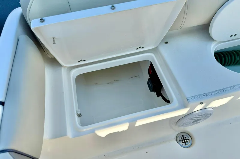 Slide: The Image of Open storage compartment on a 2022 Key West 219 FS boat, featuring a clean interior. - 40