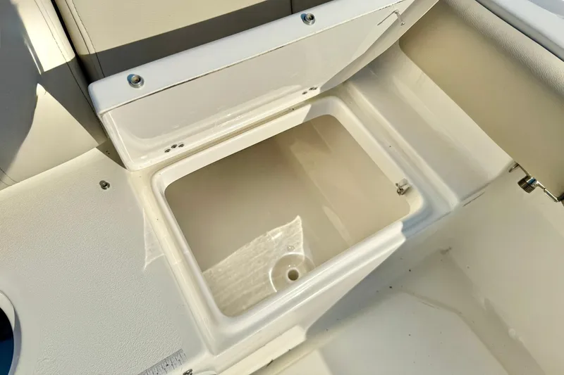 Slide: The Image of 2022 Key West 219 FS boat storage compartment, open and empty, with white interior. - 42