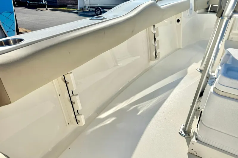 Slide: The Image of 2022 Key West 219 FS boat interior with seating and cup holders, showcasing sleek design. - 44