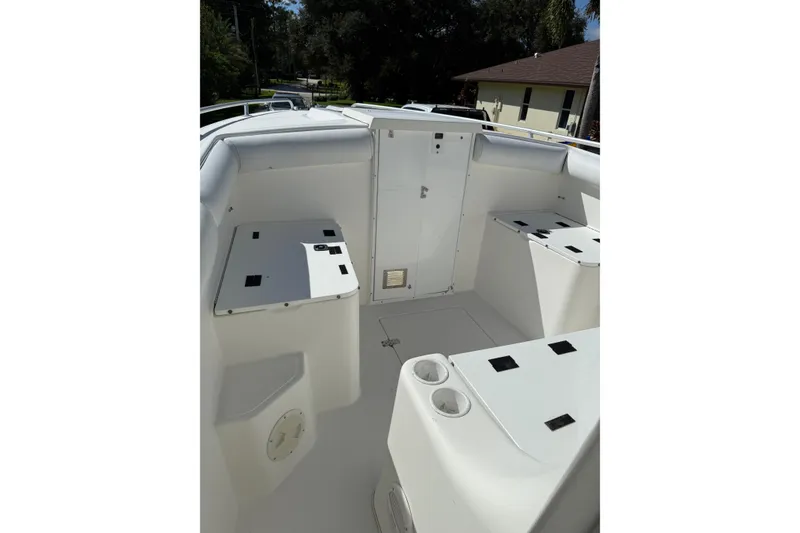 Slide: The Image of 2001 Marlago 35 Cuddy boat interior with seating and storage compartments. - 13