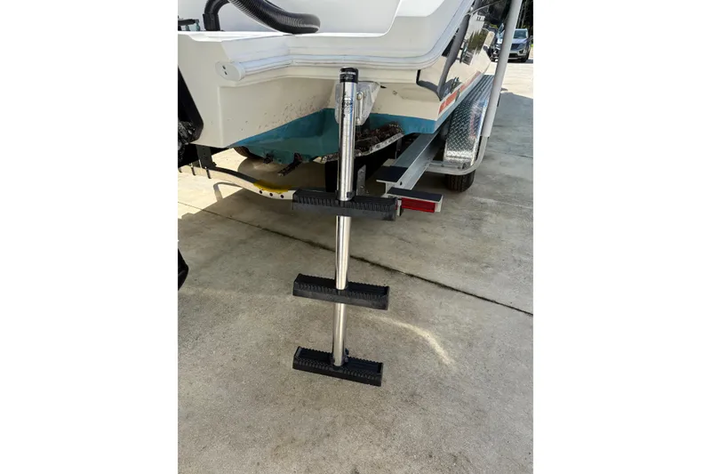 Slide: The Image of Rear view of 2001 Marlago 35 Cuddy boat with extended boarding ladder. - 23