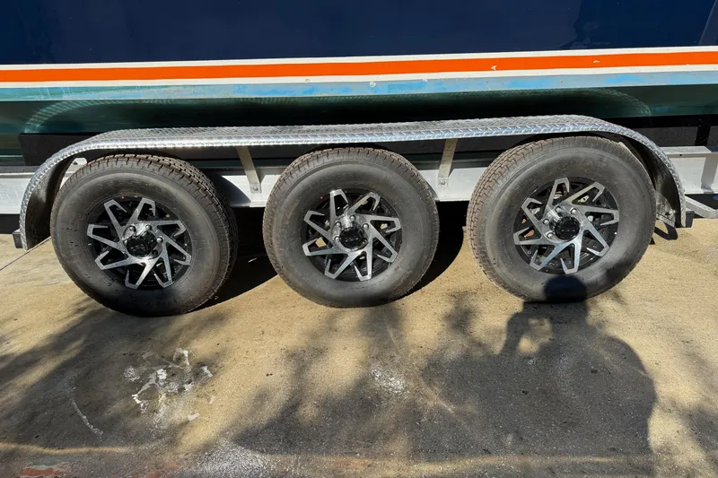 Slide: The Image of Triple-axle trailer for 2001 Marlago 35 Cuddy boat, featuring stylish alloy wheels. - 26