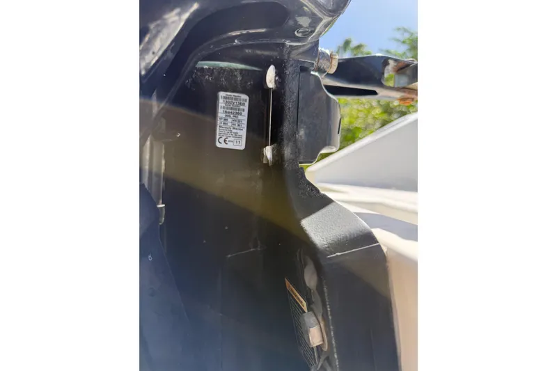 Slide: The Image of Close-up of a 2001 Marlago 35 Cuddy boat component with visible label and hardware. - 28