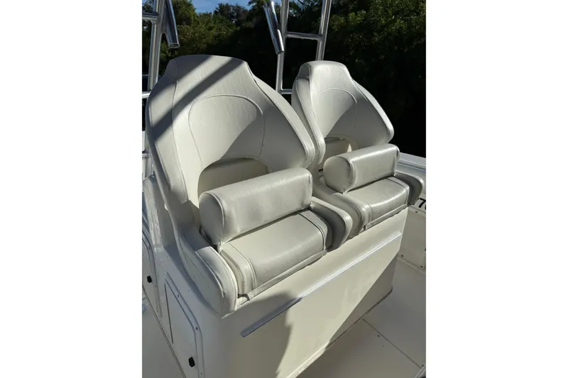Slide: The Image of 2001 Marlago 35 Cuddy boat with two white cushioned seats. - 31