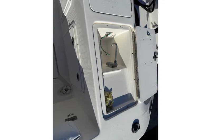 Slide: The Image of 2001 Marlago 35 Cuddy boat compartment with open storage and visible wiring. - 32