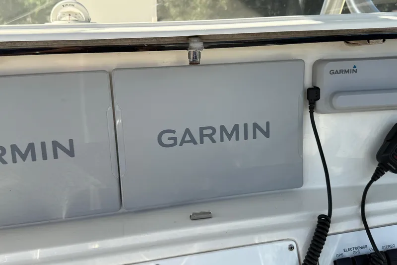 Slide: The Image of Garmin navigation system on 2001 Marlago 35 Cuddy boat dashboard. - 34