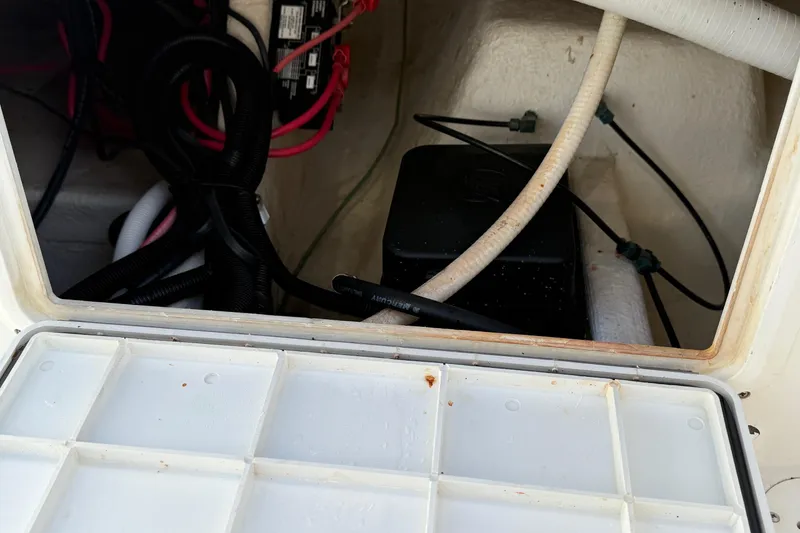 Slide: The Image of 2001 Marlago 35 Cuddy boat interior wiring and storage compartment. - 36