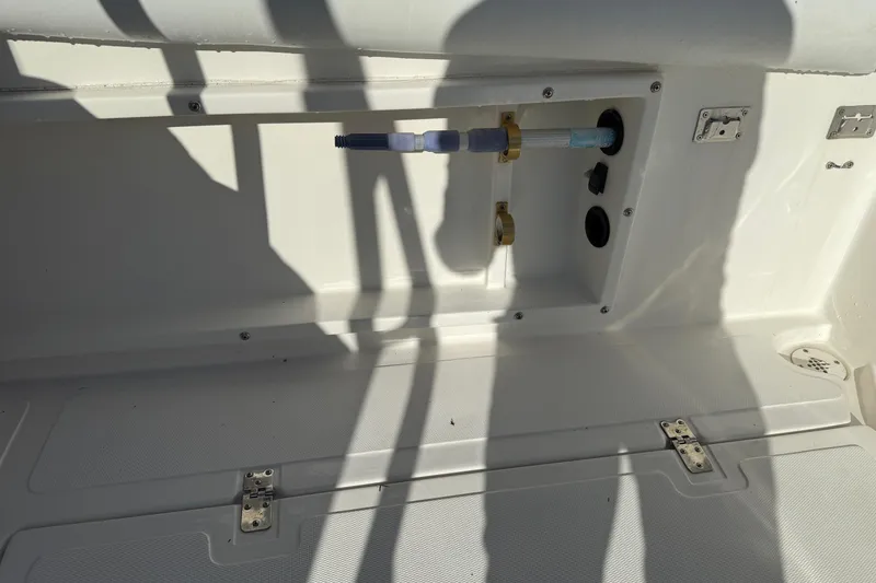Slide: The Image of 2001 Marlago 35 Cuddy boat interior showing utility compartment and fittings. - 37