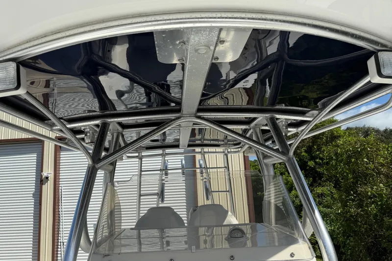 Slide: The Image of 2001 Marlago 35 Cuddy boat with sleek metal framework and canopy. - 9