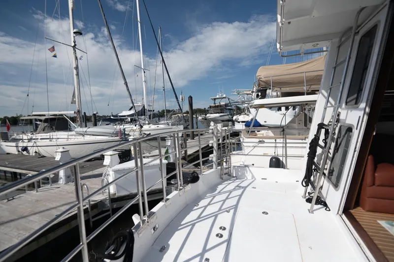 Slide: The Image of 2007 Pilot Cruiser Expedition yacht docked at marina under clear blue sky. - 12