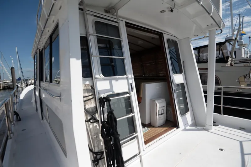 Slide: The Image of 2007 Pilot Cruiser Expedition yacht with open cabin door, docked at marina. - 13