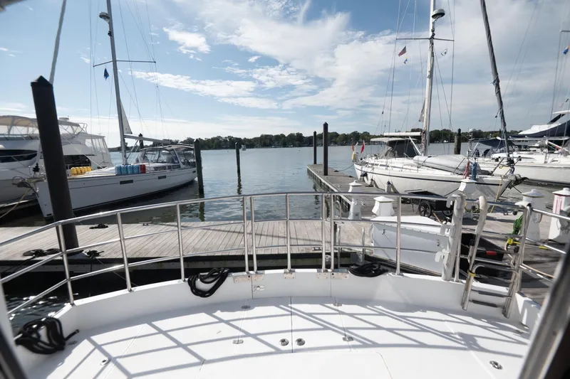Slide: The Image of 2007 Pilot Cruiser Expedition yacht docked at marina with sailboats and clear sky. - 14