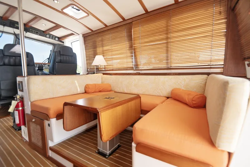Slide: The Image of Cozy interior of 2007 Pilot Cruiser Expedition with orange seating and wooden accents. - 16