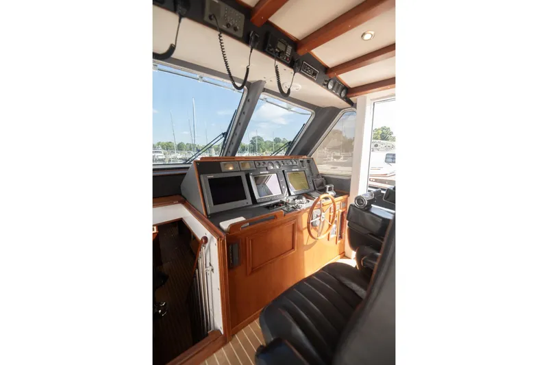 Slide: The Image of 2007 Pilot Cruiser Expedition helm with navigation equipment and wooden steering wheel. - 19