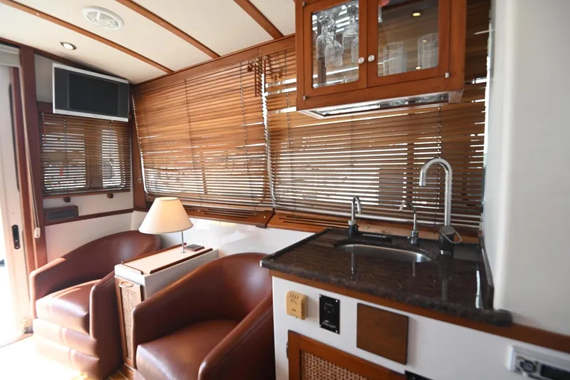Slide: The Image of Luxurious 2007 Pilot Cruiser Expedition yacht interior with leather chairs and kitchenette. - 28