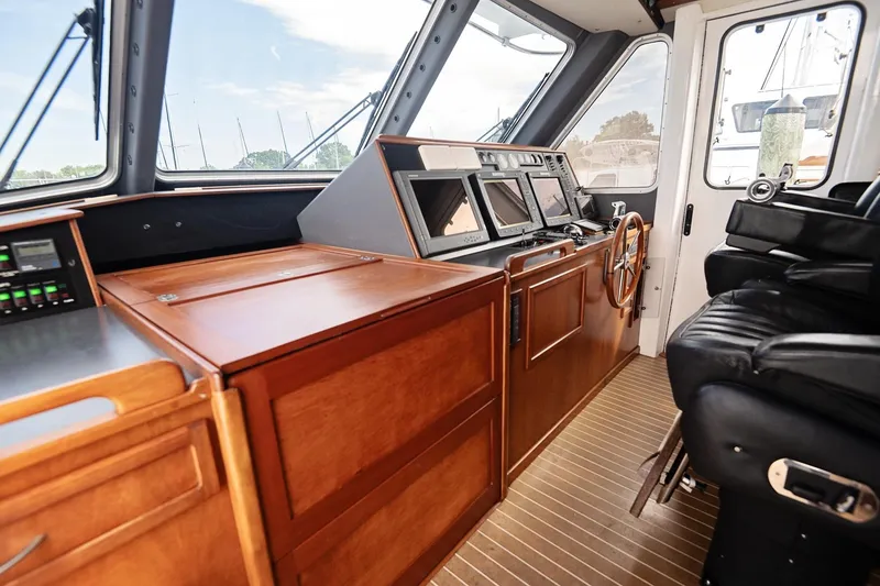 Slide: The Image of 2007 Pilot Cruiser Expedition yacht cockpit with wooden dashboard and modern navigation equipment. - 30