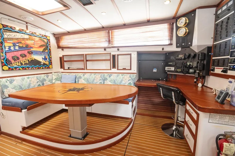 Slide: The Image of 2007 Pilot Cruiser Expedition yacht interior with dining area, navigation equipment, and vibrant wall art. - 32