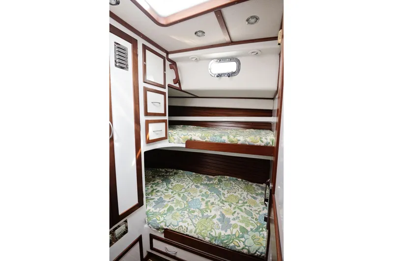 Slide: The Image of 2007 Pilot Cruiser Expedition cabin with bunk beds and floral bedding. - 42