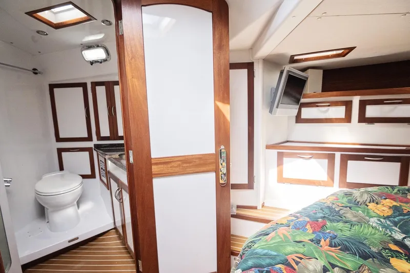 Slide: The Image of 2007 Pilot Cruiser Expedition interior with bathroom, bed, and TV in a compact cabin. - 44