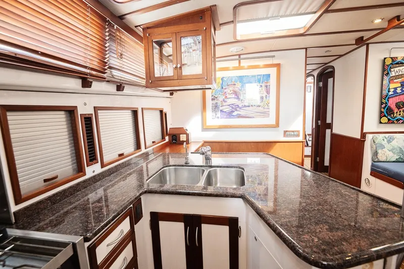 Slide: The Image of Luxurious 2007 Pilot Cruiser Expedition yacht interior with modern kitchen and elegant wood finishes. - 53
