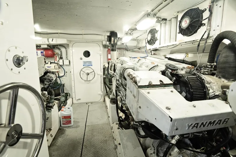 Slide: The Image of Engine room of a 2007 Pilot Cruiser Expedition, featuring Yanmar engines and mechanical equipment. - 61