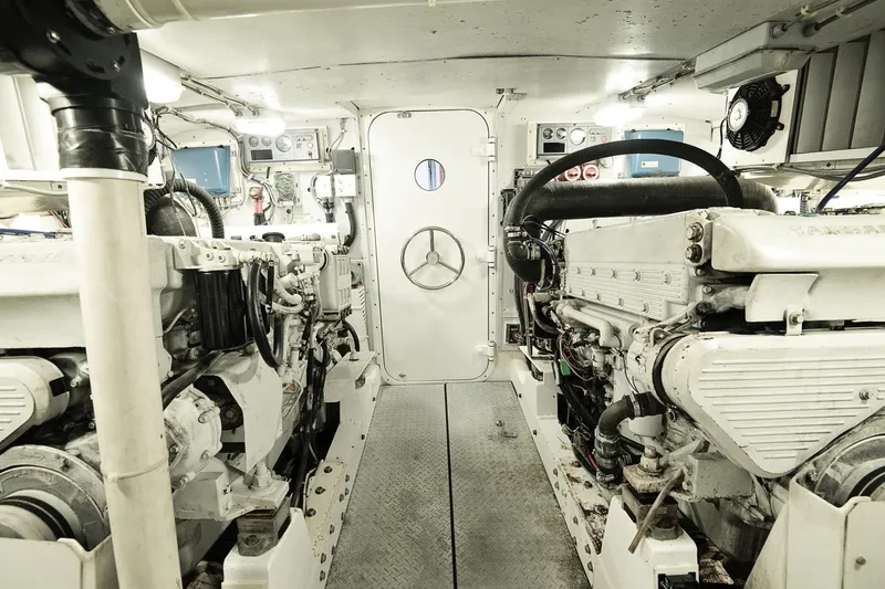 Slide: The Image of Engine room of a 2007 Pilot Cruiser Expedition yacht, featuring dual engines and control panels. - 62