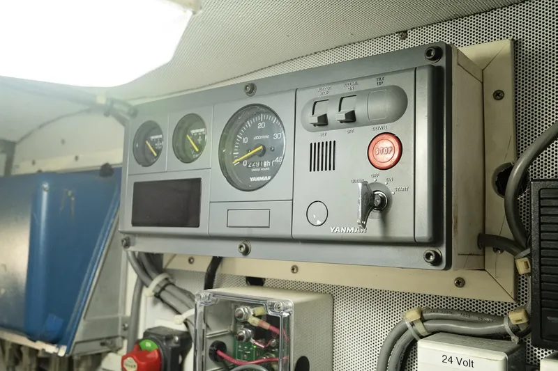 Slide: The Image of Control panel of a 2007 Pilot Cruiser Expedition boat, featuring gauges and switches. - 67
