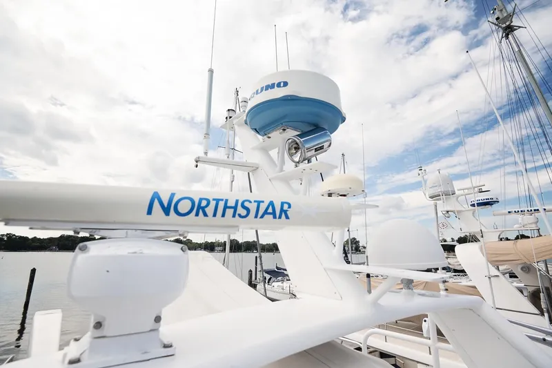 Slide: The Image of 2007 Pilot Cruiser Expedition yacht with Northstar navigation system, docked under a cloudy sky. - 72