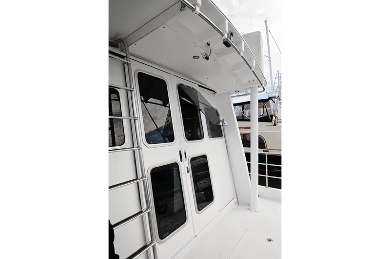 Slide: The Image of 2007 Pilot Cruiser Expedition yacht exterior with ladder and windows. - 74