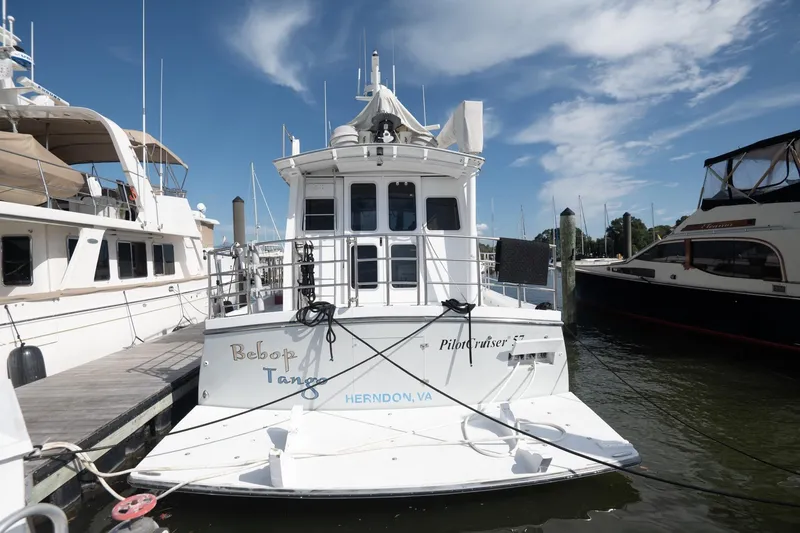 Slide: The Image of 2007 Pilot Cruiser Expedition boat docked at marina under clear blue sky. - 8