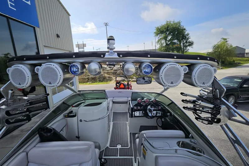Slide: The Image of 2006 MasterCraft X-80 boat interior with speakers and dashboard, parked outdoors. - 2