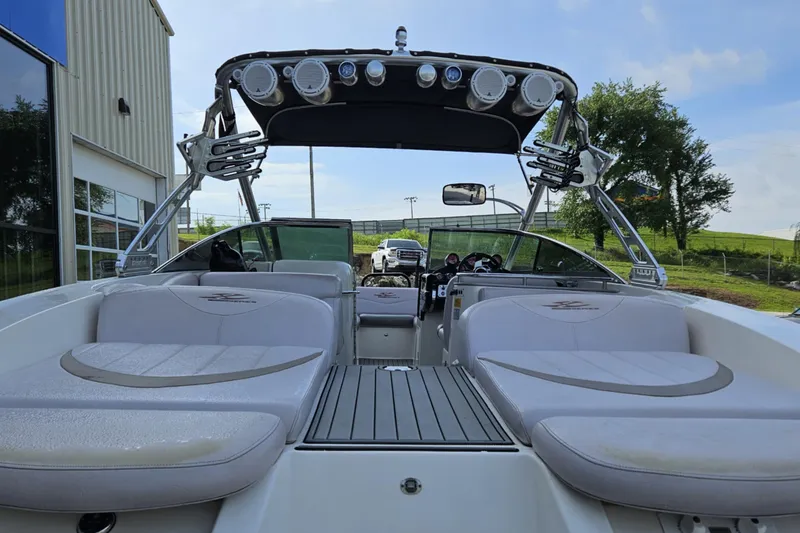 Slide: The Image of 2006 MasterCraft X-80 boat interior with seating and speakers, parked outdoors. - 9