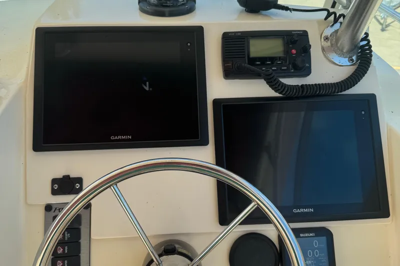 Slide: The Image of Control panel of 2008 Parker 2510 XL Walkaround with Garmin displays and VHF radio. - 12