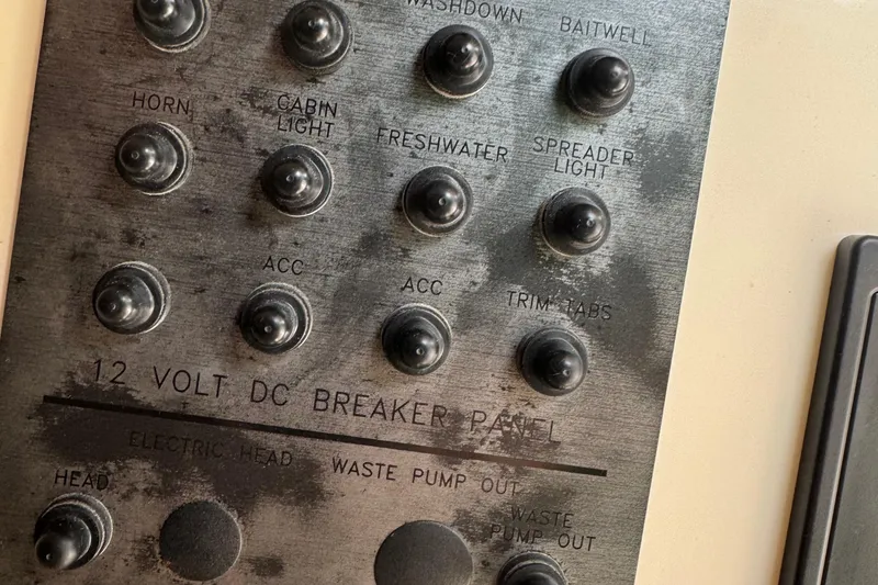 Slide: The Image of Control panel of a 2008 Parker 2510 XL Walkaround boat with labeled switches. - 13