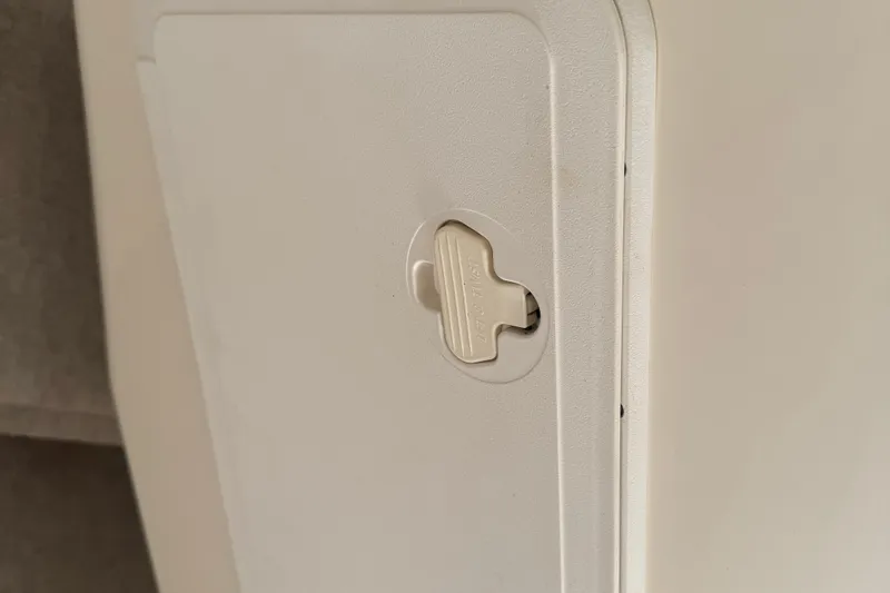 Slide: The Image of Close-up of a 2008 Parker 2510 XL Walkaround boat compartment latch. - 15