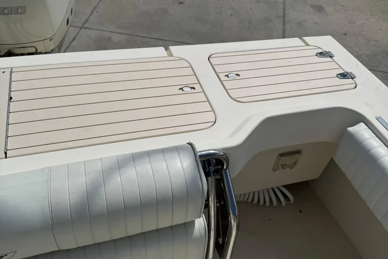 Slide: The Image of 2008 Parker 2510 XL Walkaround boat deck with cushioned seating and storage compartments. - 23