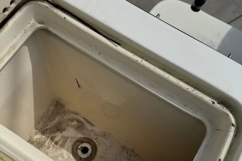 Slide: The Image of Open storage compartment on 2008 Parker 2510 XL Walkaround boat, showing interior details. - 24