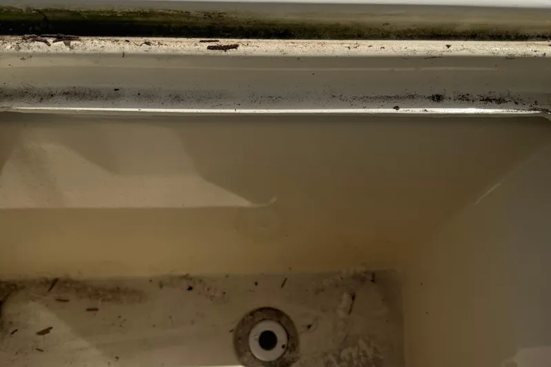 Slide: The Image of Dirty compartment of 2008 Parker 2510 XL Walkaround boat, showing grime and debris. - 26