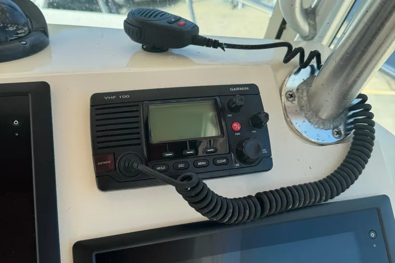 Slide: The Image of Garmin VHF 100 radio on 2008 Parker 2510 XL Walkaround boat dashboard. - 9