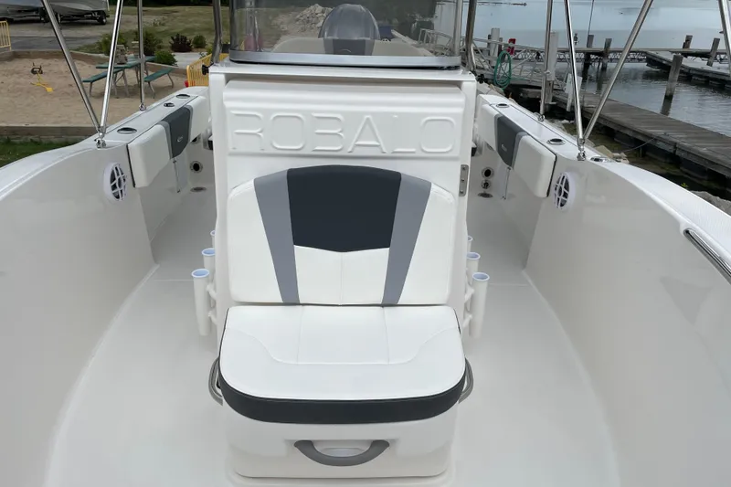 Slide: The Image of 2026 Robalo R180 Center Console boat interior with seating and cup holders. - 11