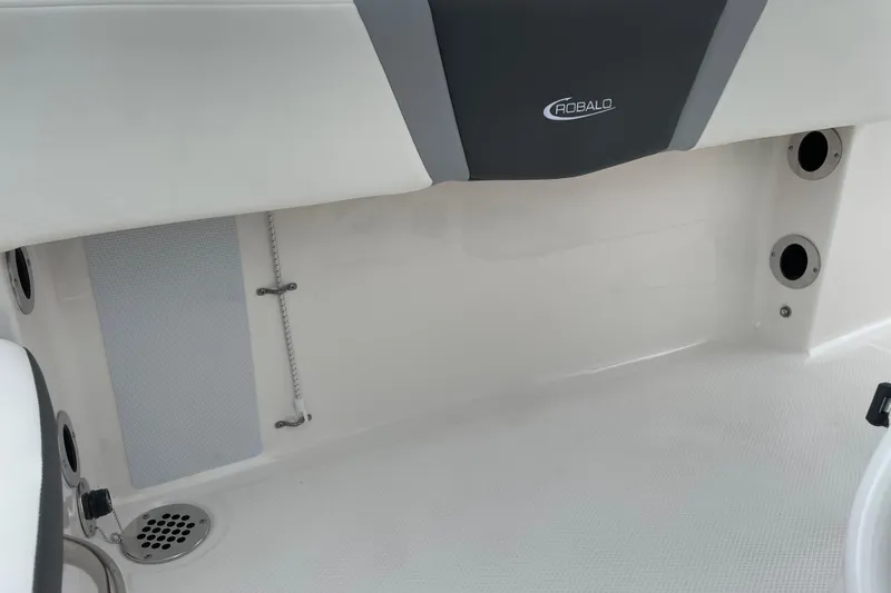 Slide: The Image of 2026 Robalo R180 Center Console interior detail with drainage and storage features. - 16